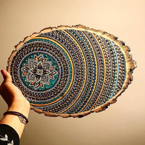 7 X 10.5 wood slice mandala. Drawn in black ink, colored in with blue, green, orange, teal, and bright blue marker, adorned with blue, green, and gold paint dots. 

SOLD OUT!!